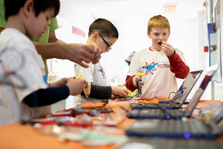 Participants in the 2018 Science Festival work on computers Participants in the 2018 Science Festival work on computers