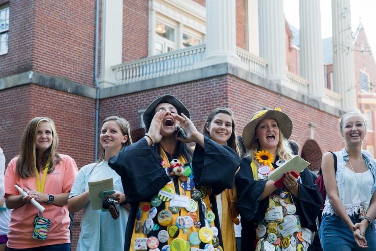 Seniors will wear their graduation robes (decked out in buttons) and funny hats to the ceremony