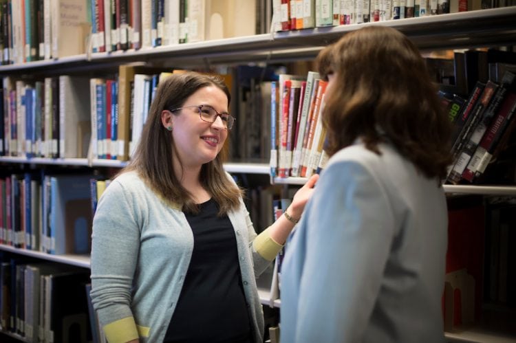 Elizabeth Cole Schlackman interacts with a library patron