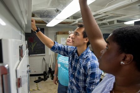 Alex Kulvivat (center) tests the environmental chamber at Randolph while Sarah Sojka and Jdody Misidor stand by