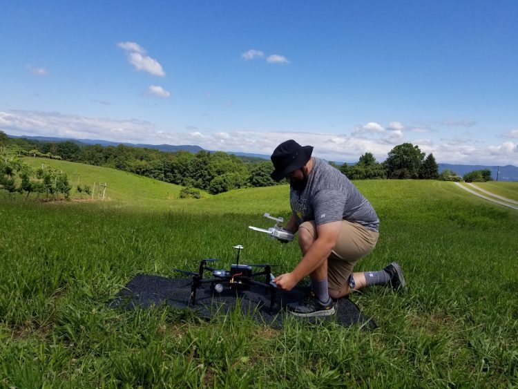 Mitchell Doss prepares a DJI Matrice 100 drone for take-off