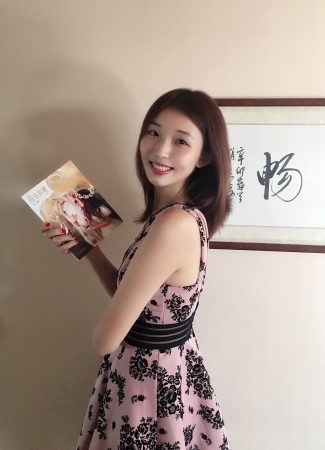 Di Bei holds a copy of her book