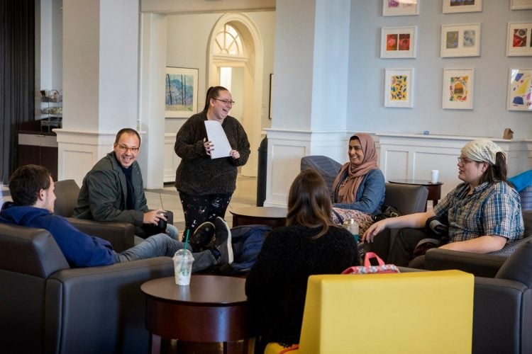 Religious studies professor Gordon Steffey meets with a group of students in the Student Center during his office hours