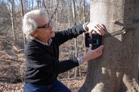 David Schwartz, a philosophy professor, works with students on back campus.