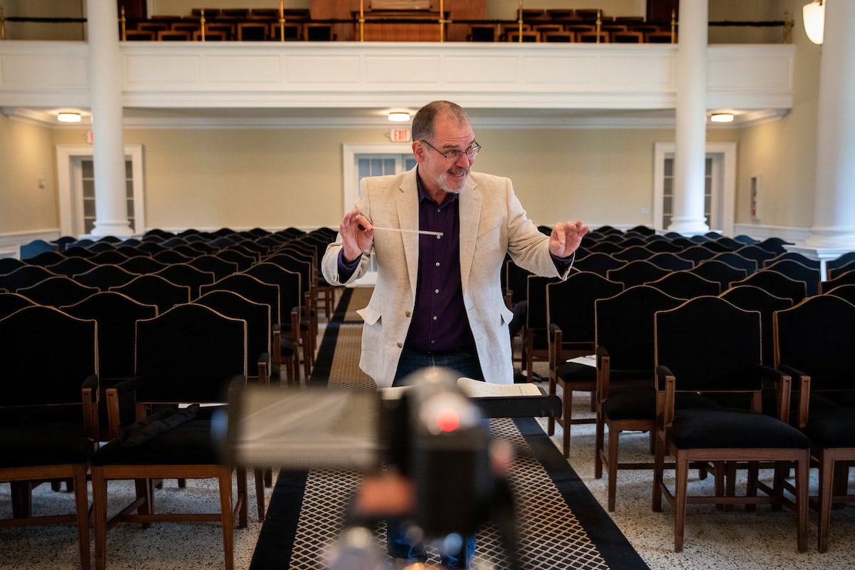 Music professor Randall Speer recorded himself conducting with an accompanist to send to chorale and orchestra students, so they could record themselves performing along to the same master track. The video was shot from multiple angles to give each group a unique view.