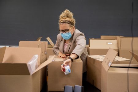 Visiting biology professor Erin Heller gets lab kits ready to ship.