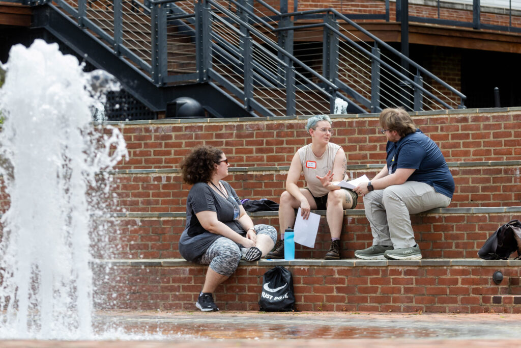 MFA students hang out in front of the fountain in Michels Plaza on the Randolph College campus.