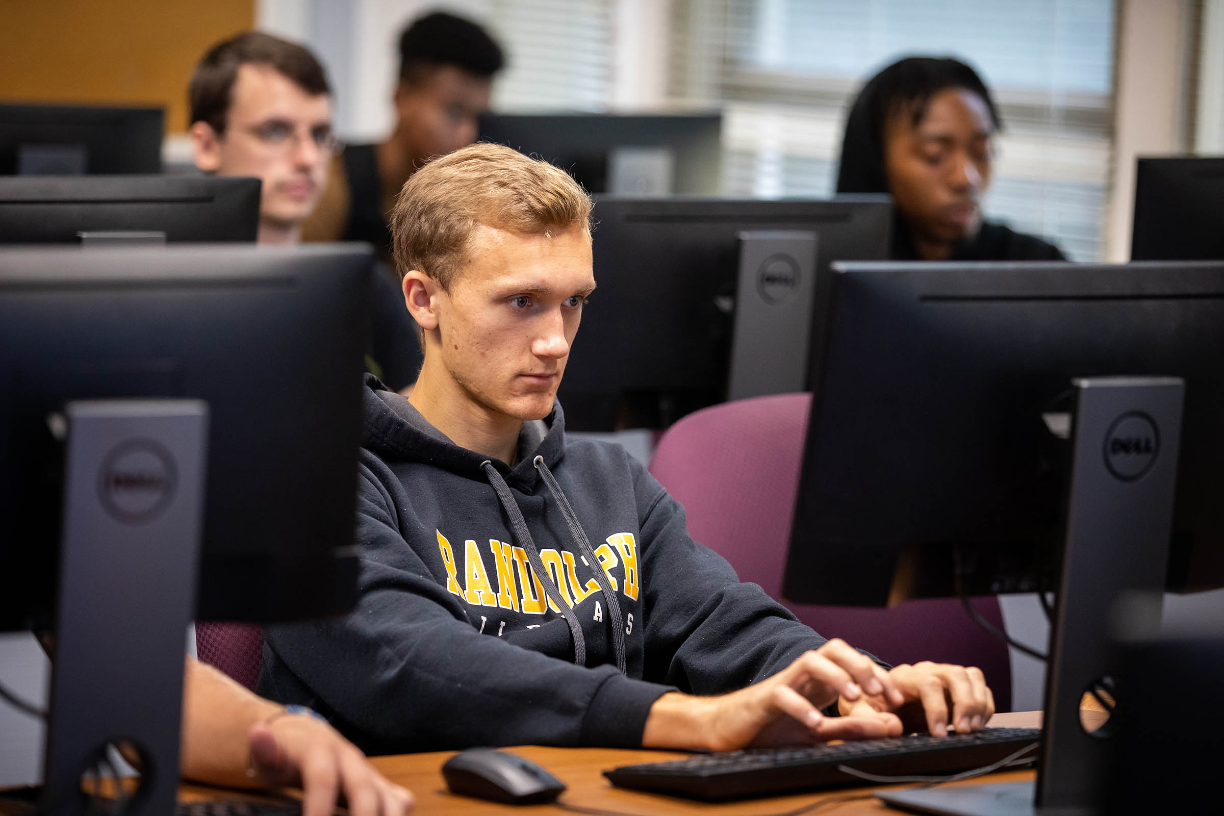 Randolph College students work on code in programming class.