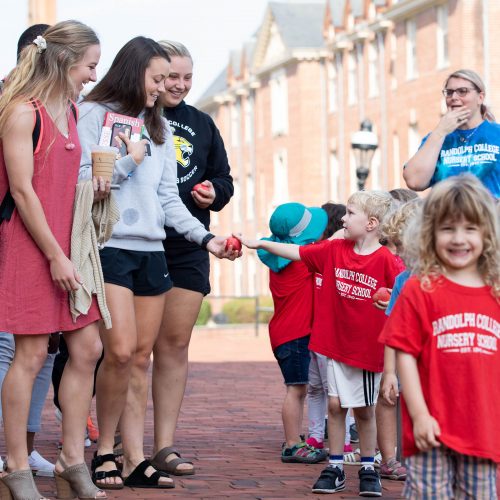 Randolph College Nursery School students hand out apples to their Randolph College 'classmates'.