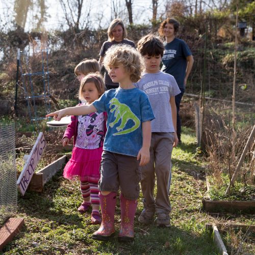 Students lead nursery school children on a nature walk through the College's Organic Garden.