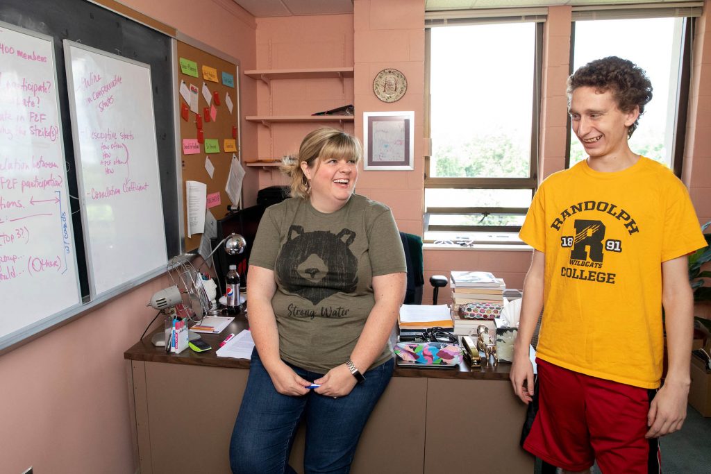 Professor Crystal Howell and Caleb Schmitzer '21 go over their notes from his Summer Research project on the use of social media in teacher strikes.