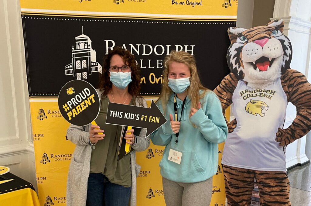 A mother and student pose for a selfie at an event on campus