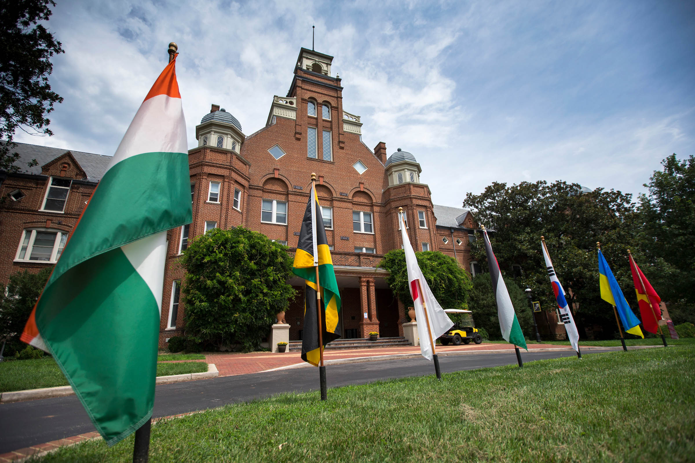 Flags of the countries of Randolph international students fly in front of Main Hall.