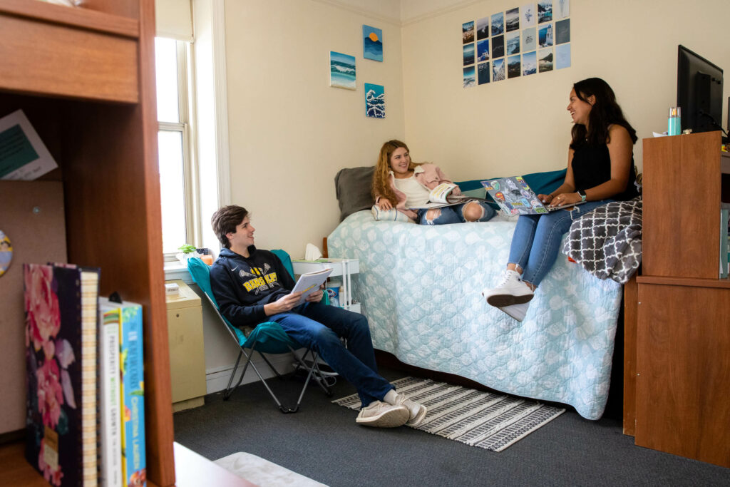 Students hang out in a residence hall room.