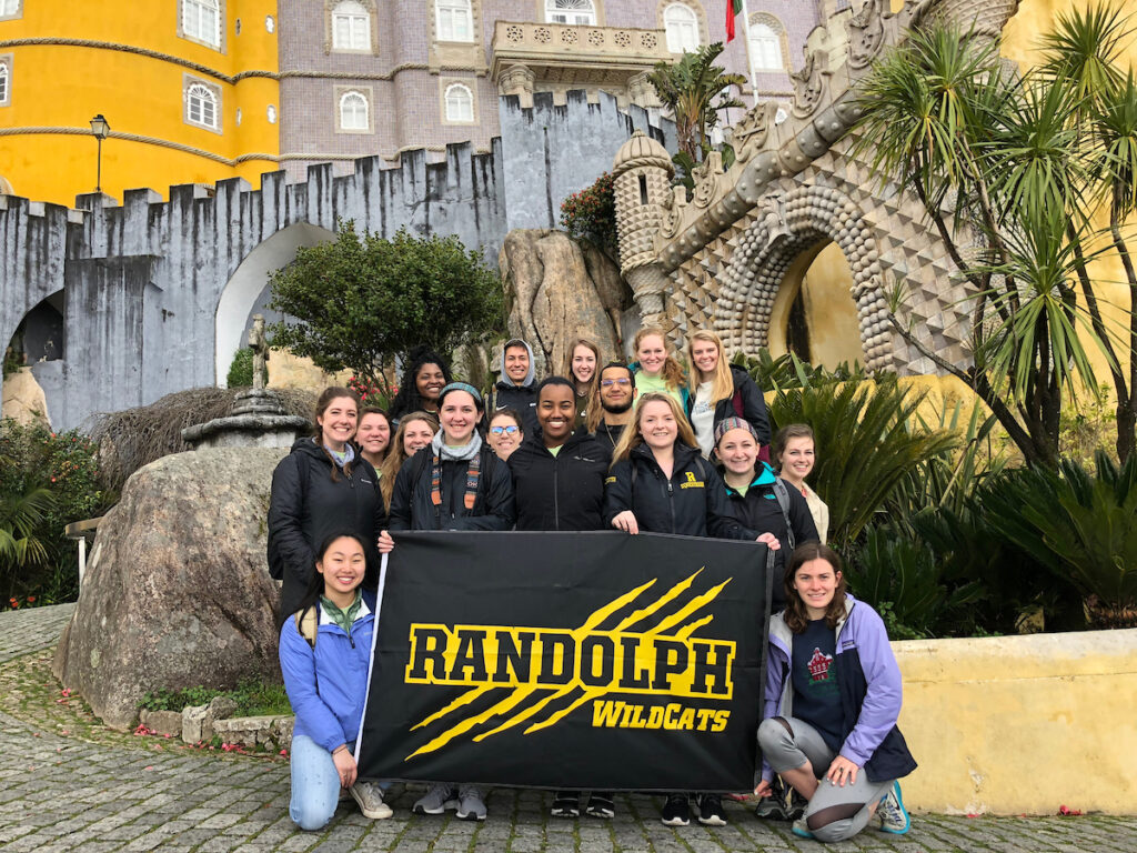 Students raise the Randolph College banner in Portugal.