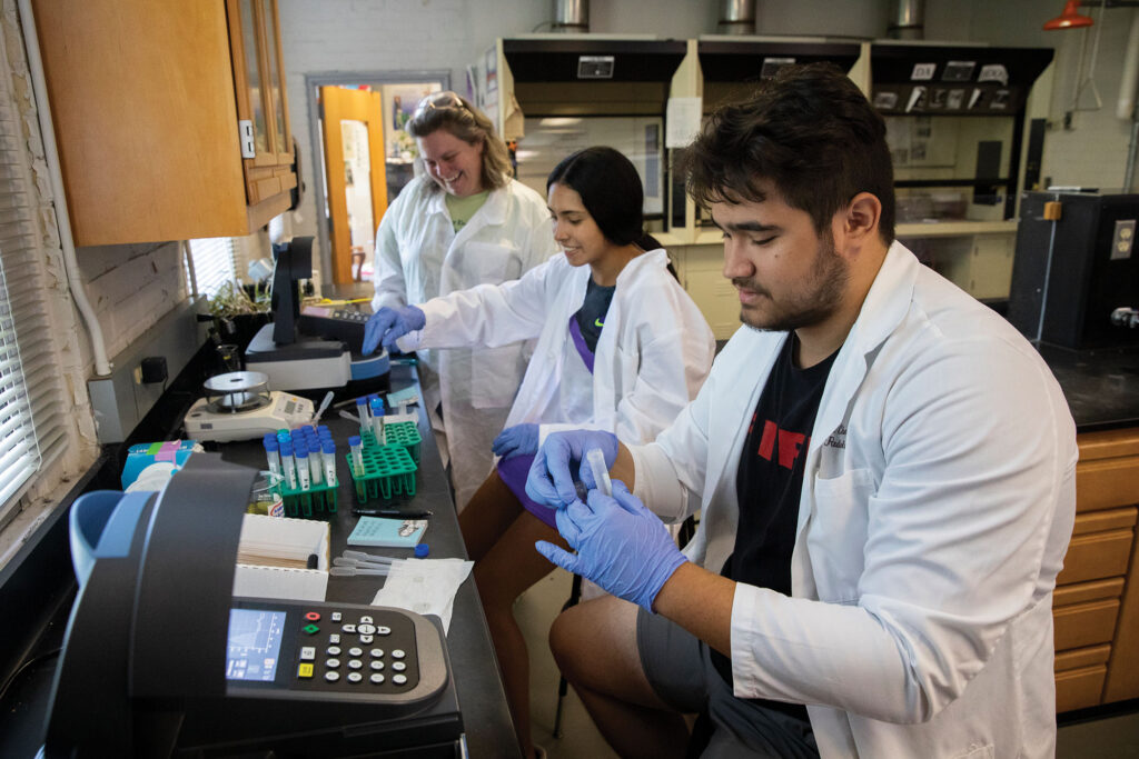 Students and their professor test samples collected in the field.