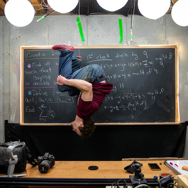 Randolph math professor Michael Penn throws in one of his signature backflips while recording a video for his popular YouTube channel.