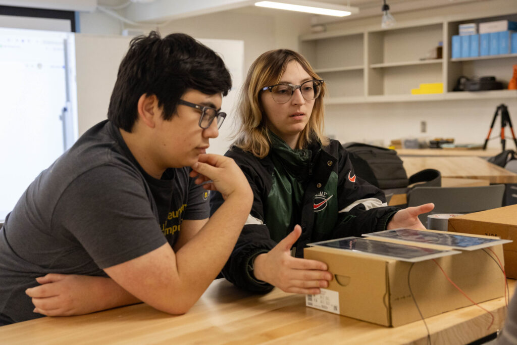 Two engineering students test solar panels for the solar powered car laboratory exercise.