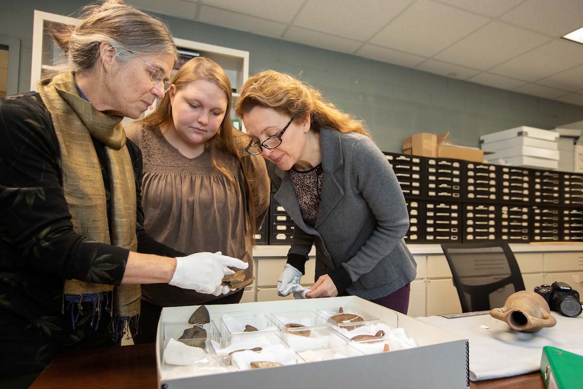 Susan Stevens, a classics professor, Sara Primm ’20, and Andrea Campbell, an art history professor, work in the new Ancient Collections Room.