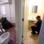 Buildings and Grounds staff member adds finishing touches to new apartments. (Photo courtesy of The News & Advance.