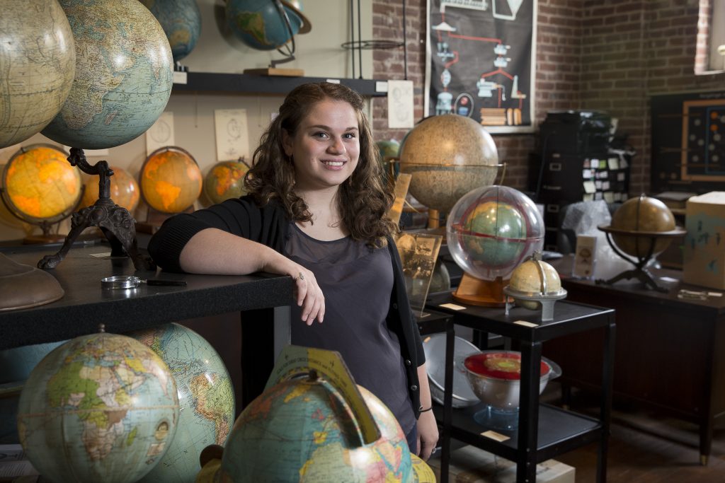 Photo of Katie Snyder with globes Photo of Katie Snyder with globes