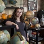 Photo of Katie Snyder with globes