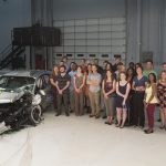 Photo of students with car