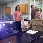 Zach Vernon ’18 (left) and Russ Burt ’16 analyze graphs of car accident statistics with physics professors Peter Sheldon and Sarah Sojka.