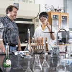 Chemistry professor Bill Bare looks at colored solutions prepared by Di Bei '18 that may be used to test water contamination levels.