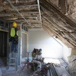 A worker frames new walls in a Wright Hall room that was completely remodeled.