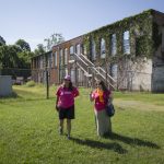 Danielle Currier (left) and Ayla Hagen '18 visit the site of a Lynchburg mill that closed in the 1950s.