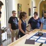 Campers built and programmed robots to play the Game of Life on a physical grid in Main Hall.