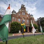 Flags from international students' home countries are on display in front of Main Hall.