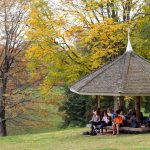 Students take class in the gazebo on front campus.