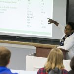 Tia Stokes-Brown ’97 goes over data from her research, entitled “The Increasing Significance of Race: Exploring the Development of Latino Racial Group Consciousness and the Link to Political Participation.”