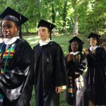 Graduates process into the Dell