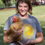 Sara Woodward '16 holds a chicken at last year's Involvement Fair.