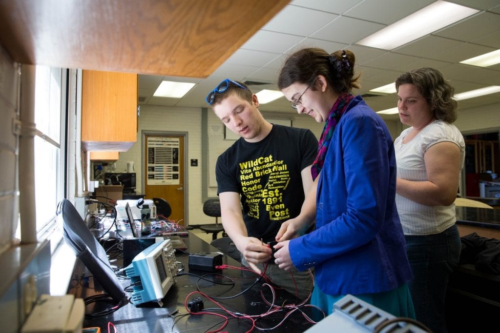 Sarah Sojka, physics and environmental studies professor, observes as Zach Vernon '18 and Leonora Bratvold-Boyd '19 conduct a lab test.