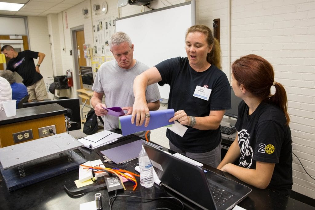 Participants in Randolph's teaching institute work together to build a structure that would be tested on the shake table.