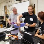 Participants in Randolph's teaching institute work together to build a structure that would be tested on the shake table.