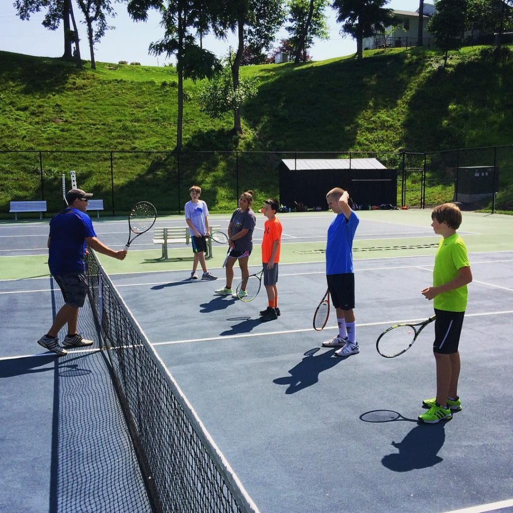 Kids receive instruction at Randolph College tennis camp.