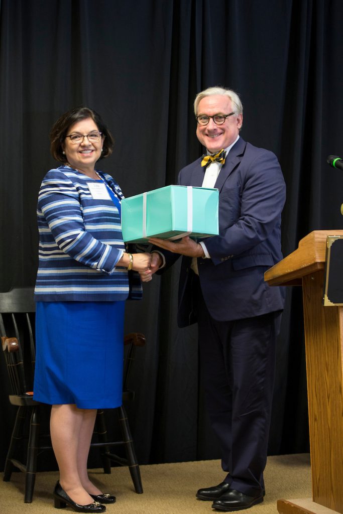 Edna Aguirre Rehbein '77 receives her Alumnae Achievement Award from President Bradley W. Bateman in September 2015.