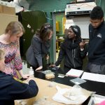 Students conduct archaeological research on African artifacts.