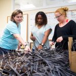 Physics and environmental studies professor Sarah Sojka, Tyrah Cobb-Davis '19, and Libby Exline '19 construct artificial seagrass