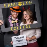 Students pose in the Giving Tuesday photo booth, holding thank you signs.