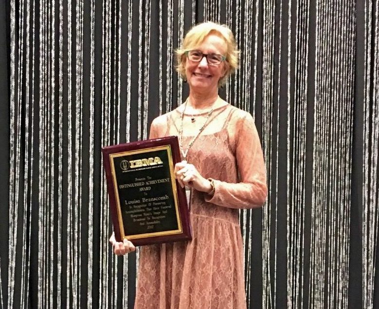 Louisa Branscomb '71 holding her 2017 Distinguished Achievement Award from the International Bluegrass Music Association. Louisa Branscomb '71 holding her 2017 Distinguished Achievement Award from the International Bluegrass Music Association.