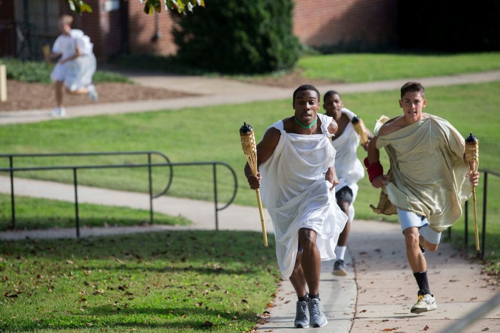 (Left) Daniel Bennett-Blake '21 inches ahead of Bradley Strober '18 during Randolph's first-ever Panathenaic Torch Relay in September.