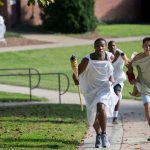 (Left) Daniel Bennett-Blake '21 inches ahead of Bradley Strober '18 during Randolph's first-ever Panathenaic Torch Relay in September.