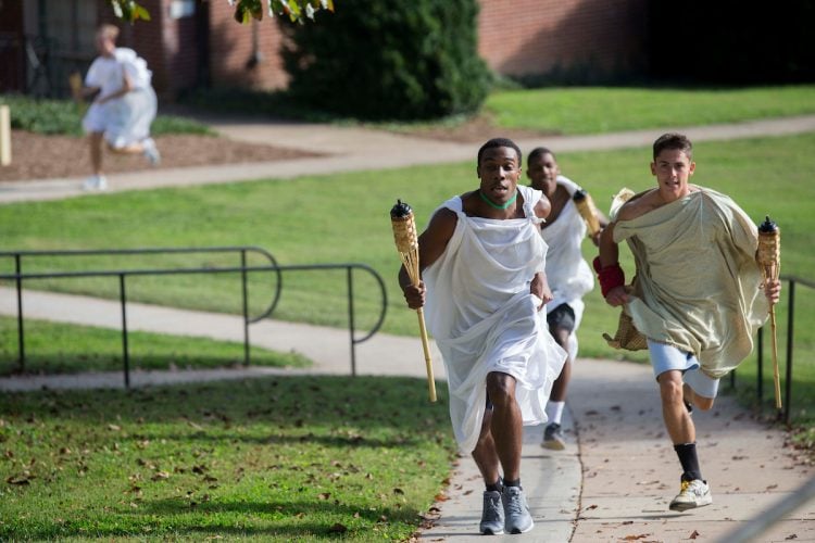 (Left) Daniel Bennett-Blake '21 inches ahead of Bradley Strober '18 during Randolph's first-ever Panathenaic Torch Relay in September. (Left) Daniel Bennett-Blake '21 inches ahead of Bradley Strober '18 during Randolph's first-ever Panathenaic Torch Relay in September.