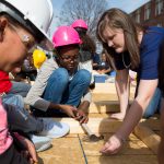 A Randolph student helps middle schoolers hammer nails.